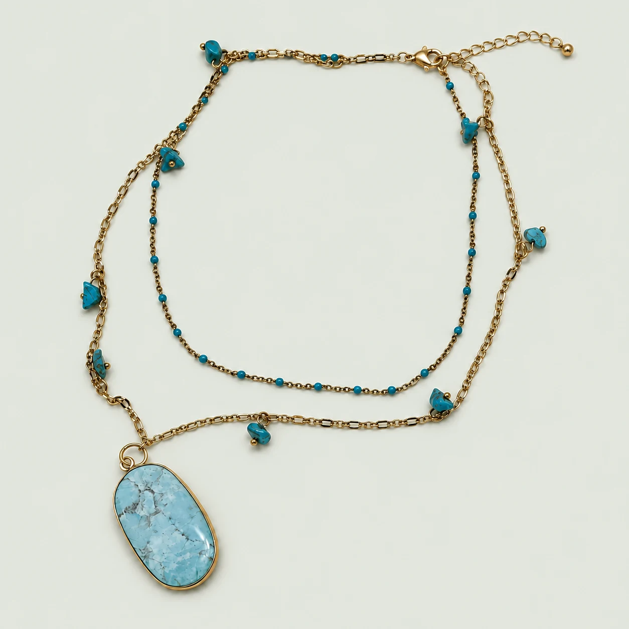 Layered necklace with a blue stone pendant